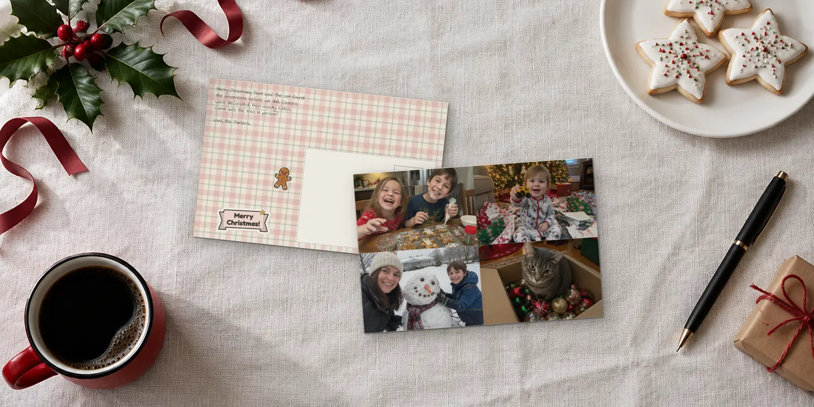 Christmas postcards on a linen tablecloth: a four-photo card with gingerbread cookies and a snowman, beside its plaid back with a Merry Christmas banner