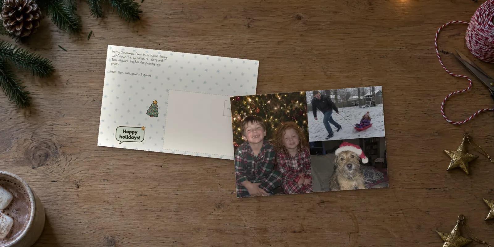 Holiday postcards on a kitchen table: a Christmas photo card with three family photos beside its snowflake back
