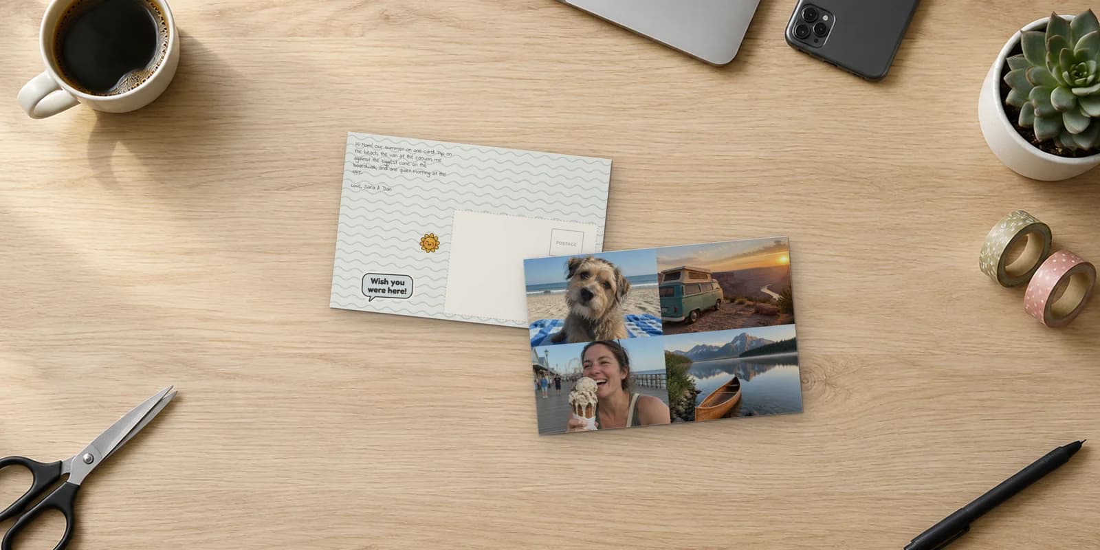 A card made in the postcard maker, on an oak desk beside a laptop and a phone: four summer photos on the front, and a wavy back with a Wish you were here sticker