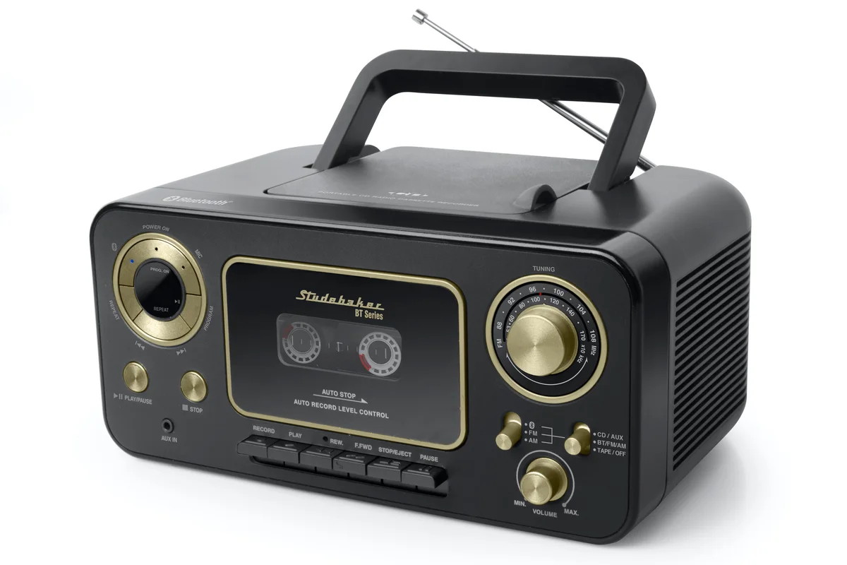 A black and gold portable CD player with an oversized play button, large tuning and volume knobs and a top-loading lid