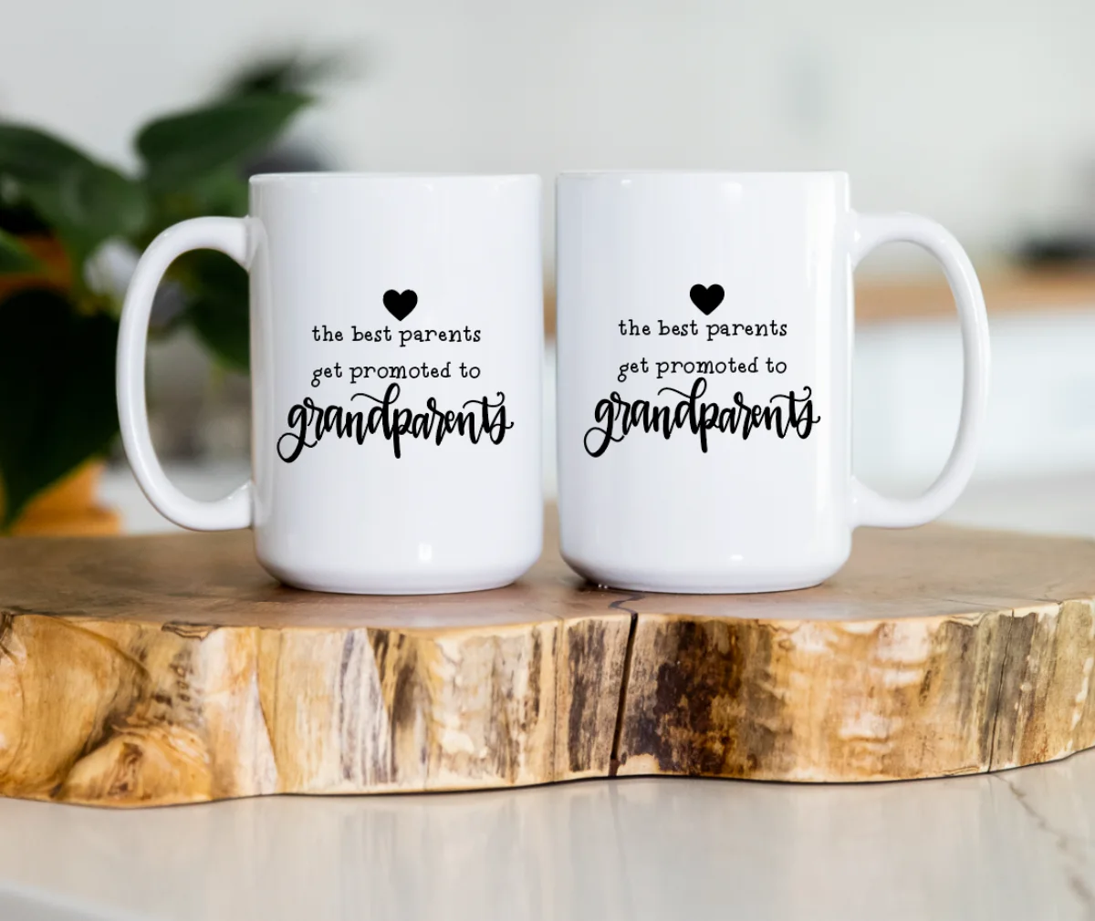 A pair of hand-lettered Promoted to Grandparents ceramic mugs