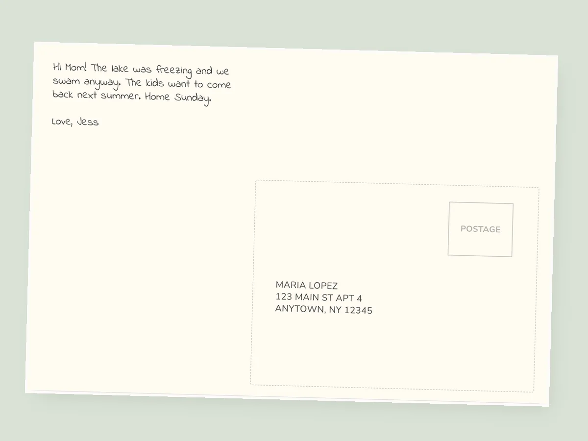 The back of a printed 4x6 postcard: a short note on the left, a postage box top right and a three-line address below it