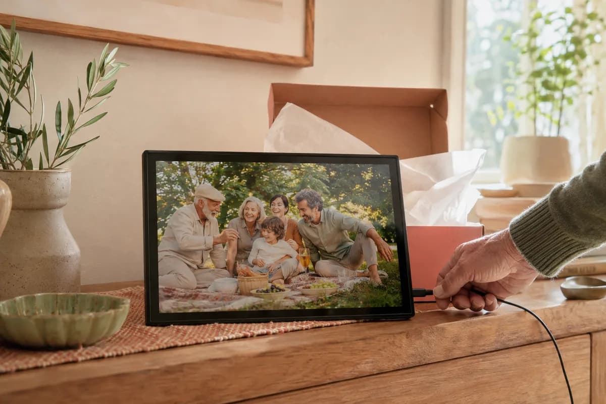 An illustrative digital photo frame preloaded with a fictional family picnic picture