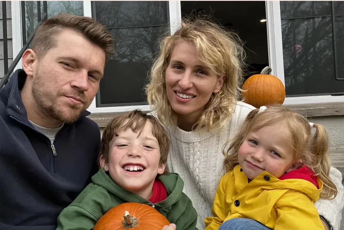 Card front with one full photo: a mom and dad on a porch with two kids holding pumpkins