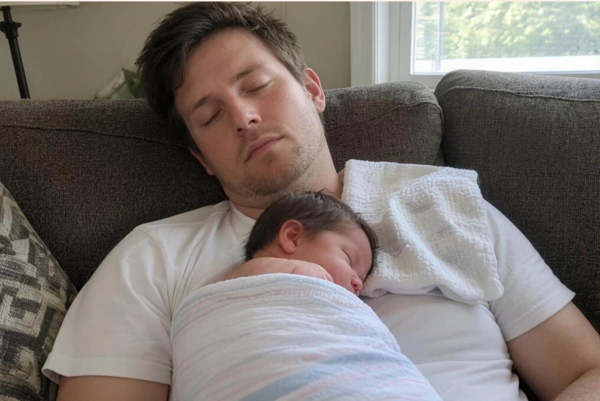 Card front with one photo of a new dad asleep on the couch with a swaddled newborn asleep on his chest