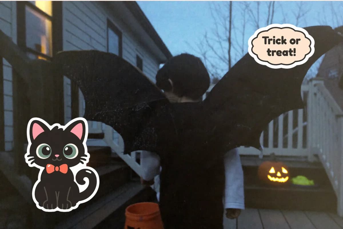 Card front with one full-size photo of a child in homemade bat wings on the porch steps, with Trick or treat! and black cat stickers