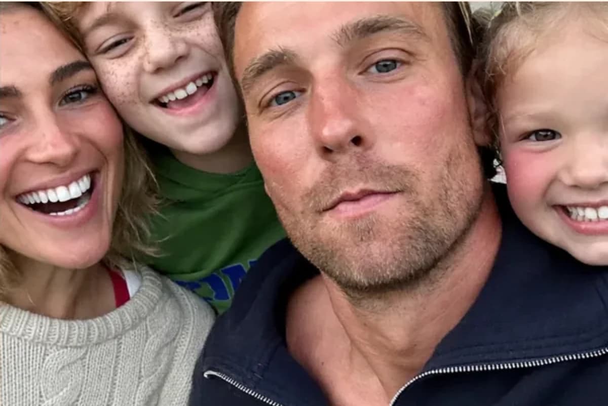 Postcard front with one full-size photo: a mom, a dad and two kids squeezed into a close-up selfie