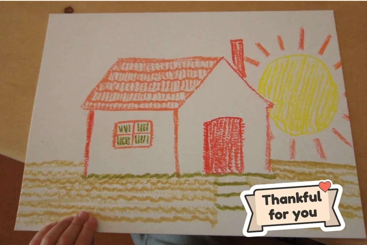 Card front with one full-size photo of a child's crayon drawing of a red house under a yellow sun, with a Thankful for you sticker